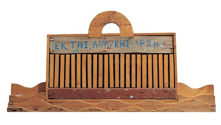 Αλέξης Ακριθάκης: «Εκ της λιμενικής αρχής», 1971· ξύλινη κατασκευή 61 x 123 x 9 εκ. (Ιδιωτική συλλογή)